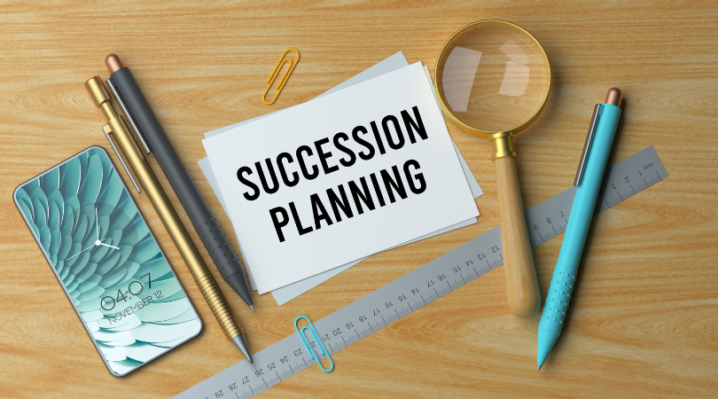 Words on a note pad which spell out Succession planning
