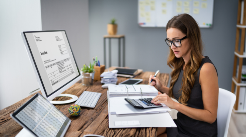 Woman working at a desk looking at charts representing accounting and finance careers in Ohio