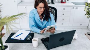 Image of woman on tablet. Learn how to optimize your linkedin profile